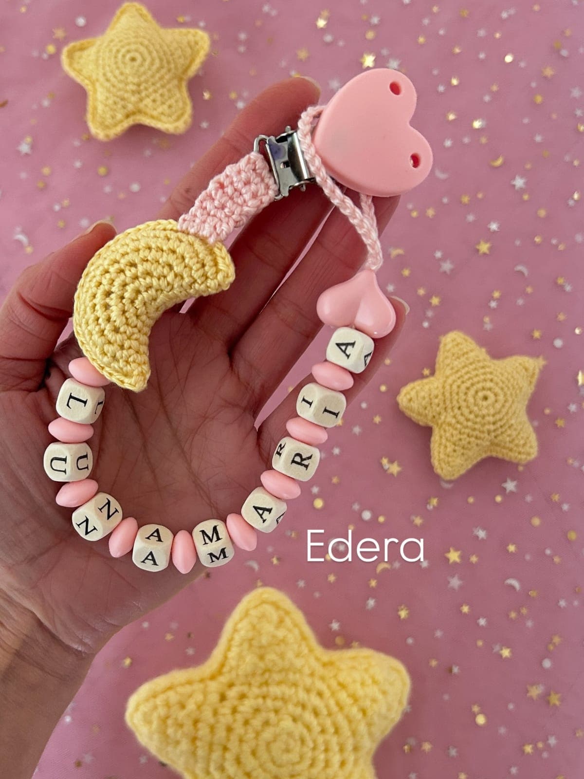 Pink pacifier clip with a crochet moon, stars and name letters