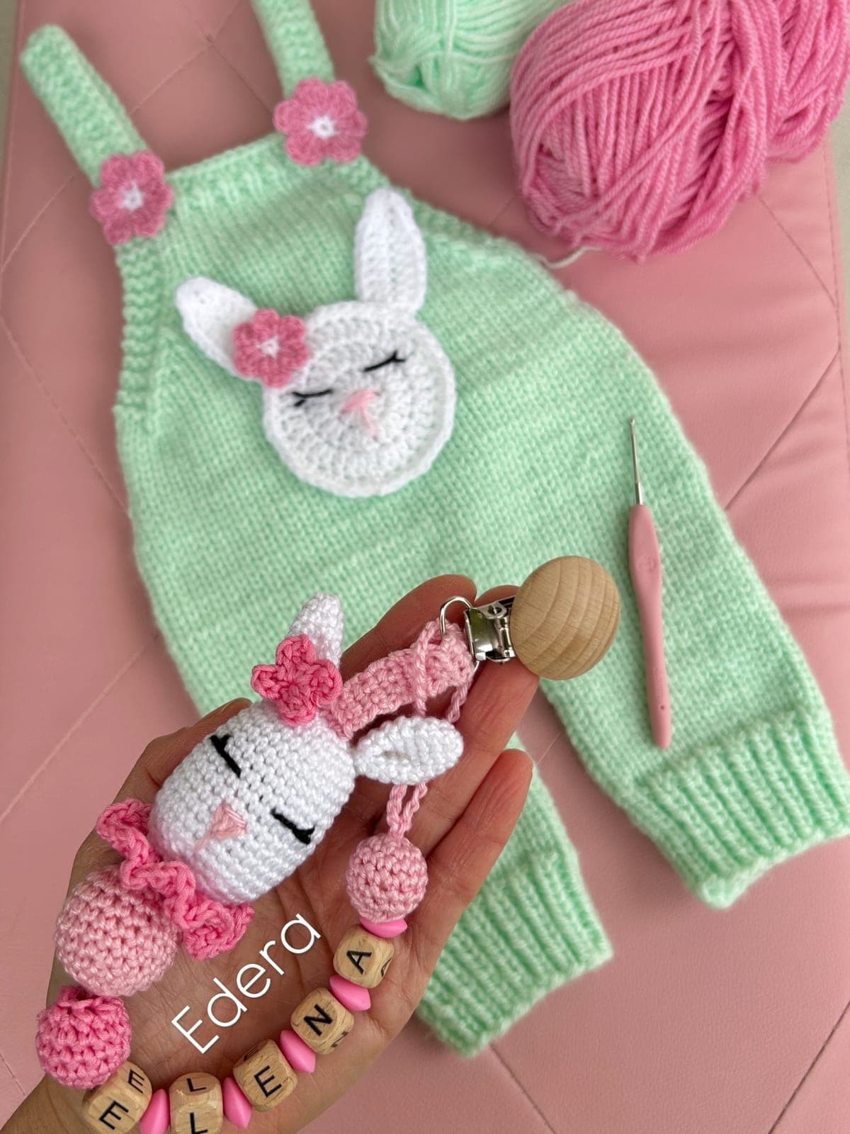 Mint knitted dungarees with a bunny and a pacifier clip with the name Elena
