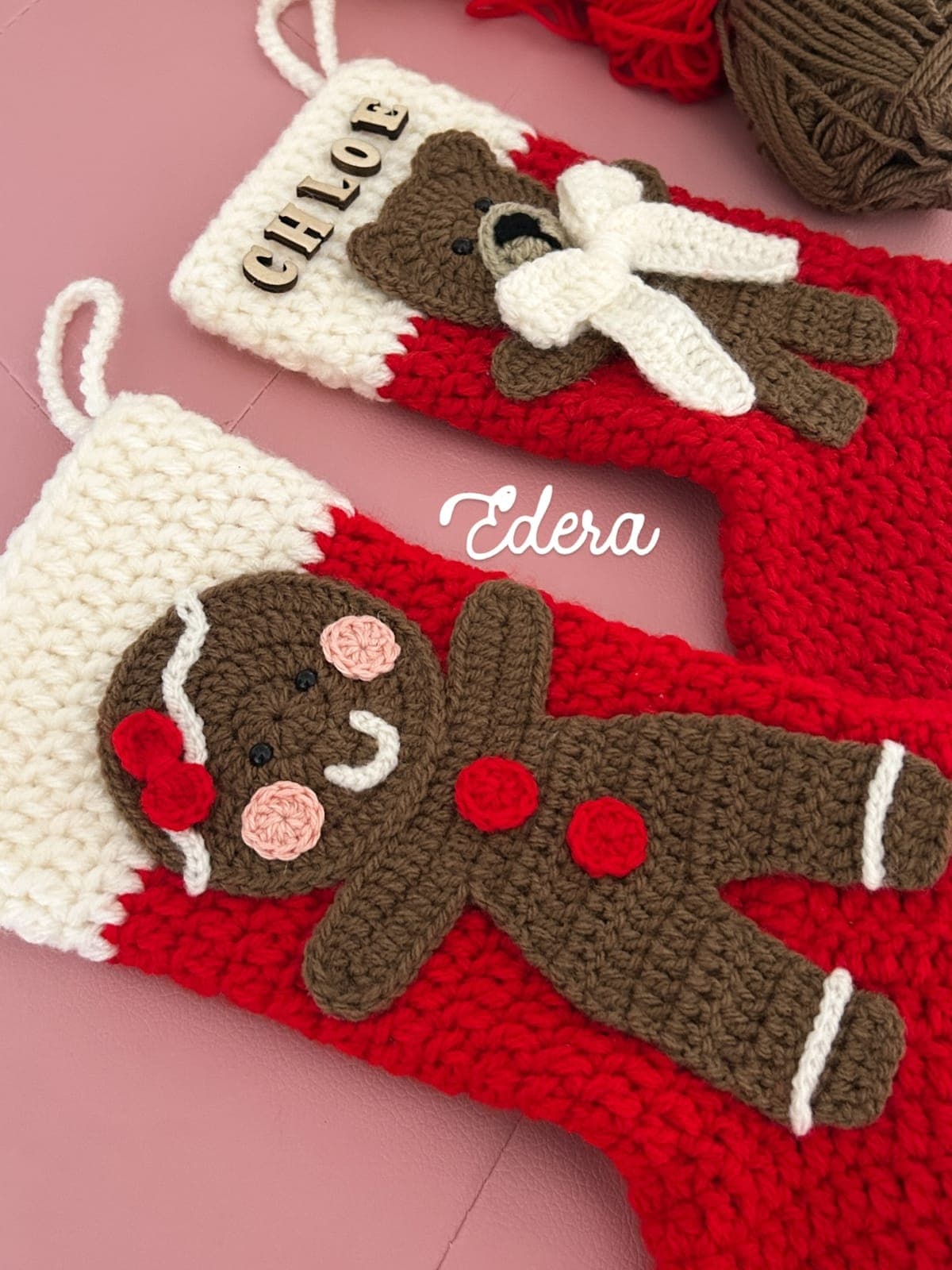 Red Christmas stockings with a crochet gingerbread man and teddy bear